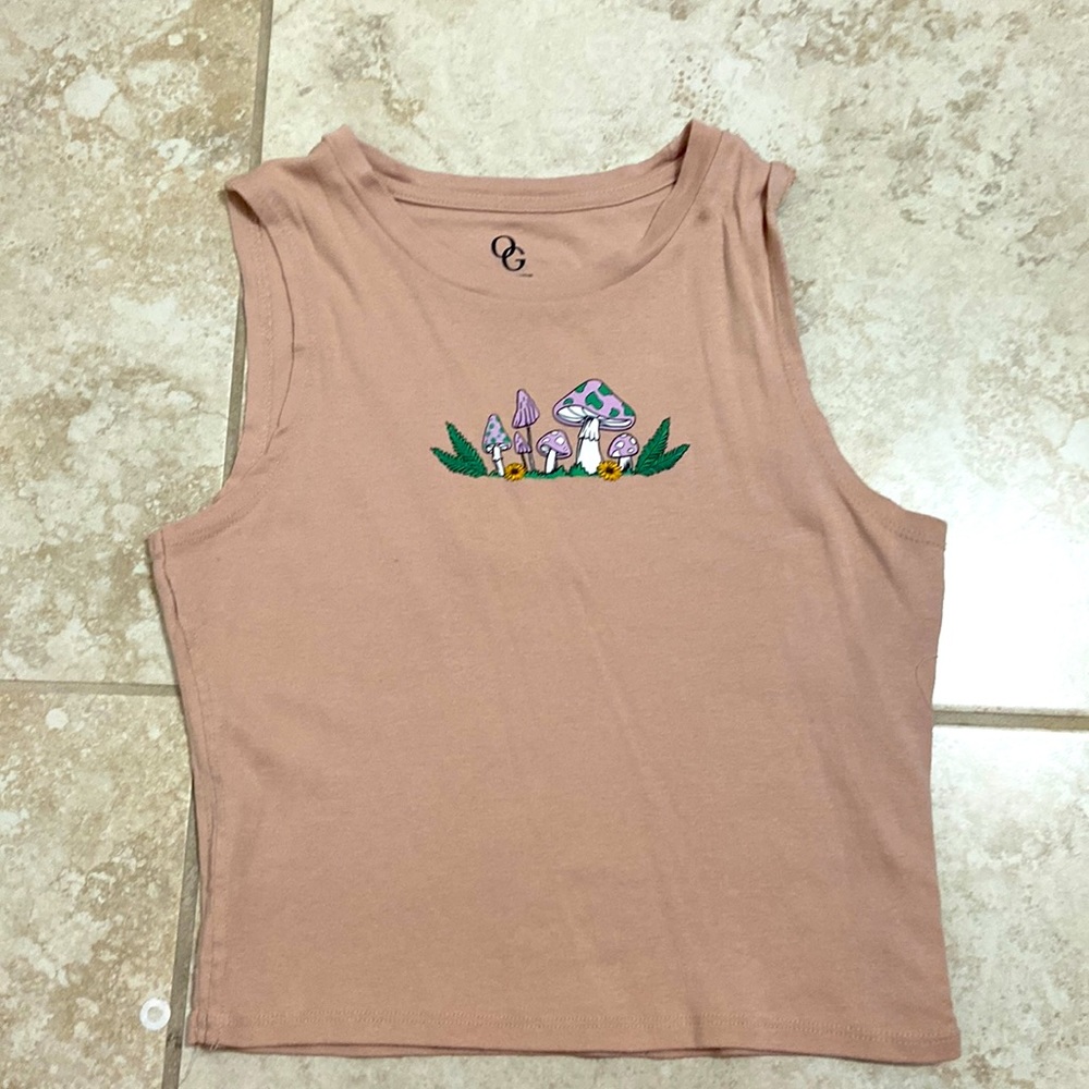 Tan colored tank top. Mushroom patterns.
